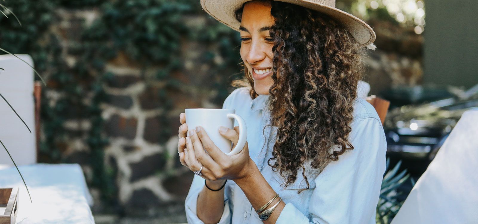 woman drinking cup of tea with Best Herbs for Anti-Aging Skin