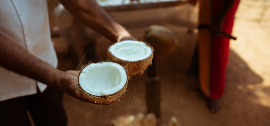 man holding coconut halves a pitta food