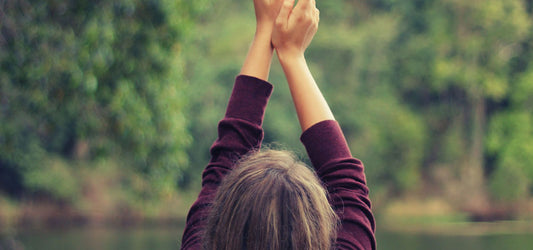 woman's arms stretching to start day with an ayurveda daily routine