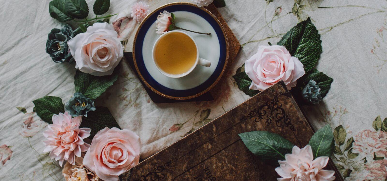 cup of tea on saucer with roses