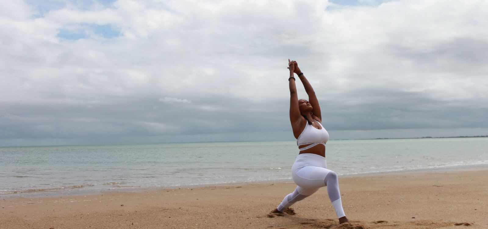woman practice yoga for digestion on beach
