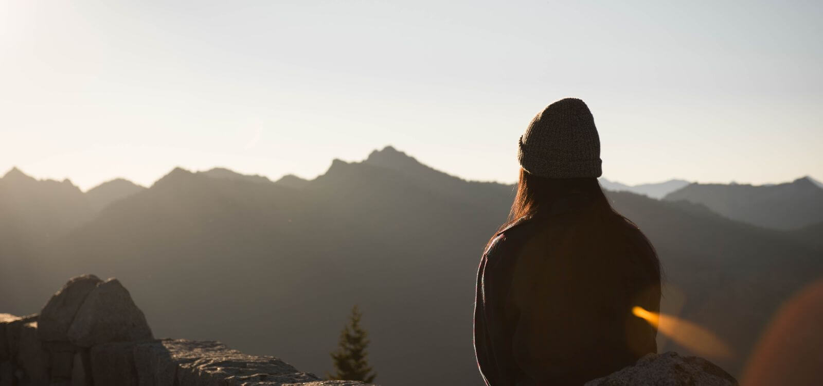 woman sitting on top of mountain in meditation