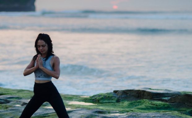 woman doing yoga following ayurveda times of day
