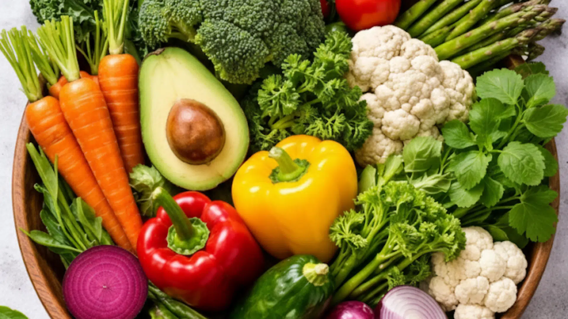 wooden harvest bowl filled with a rainbow of produce, including leafy greens, root vegetables, and cruciferous favorites