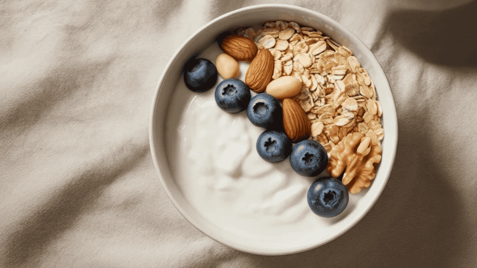 bowl of yogurt with berries oats and nuts with eggs showing natural support for yeast and gut health