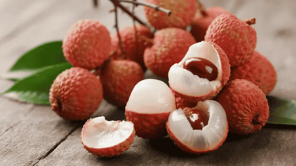 lychee fruits whole and peeled showing white flesh and brown seed naturally high in potassium for healthy fruit diet