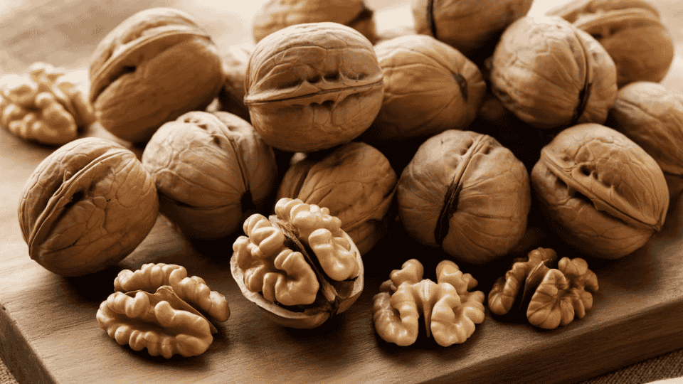 walnuts in shell and kernels on wooden surface potassium rich nuts healthy snack ingredient for balanced diet and nutrition