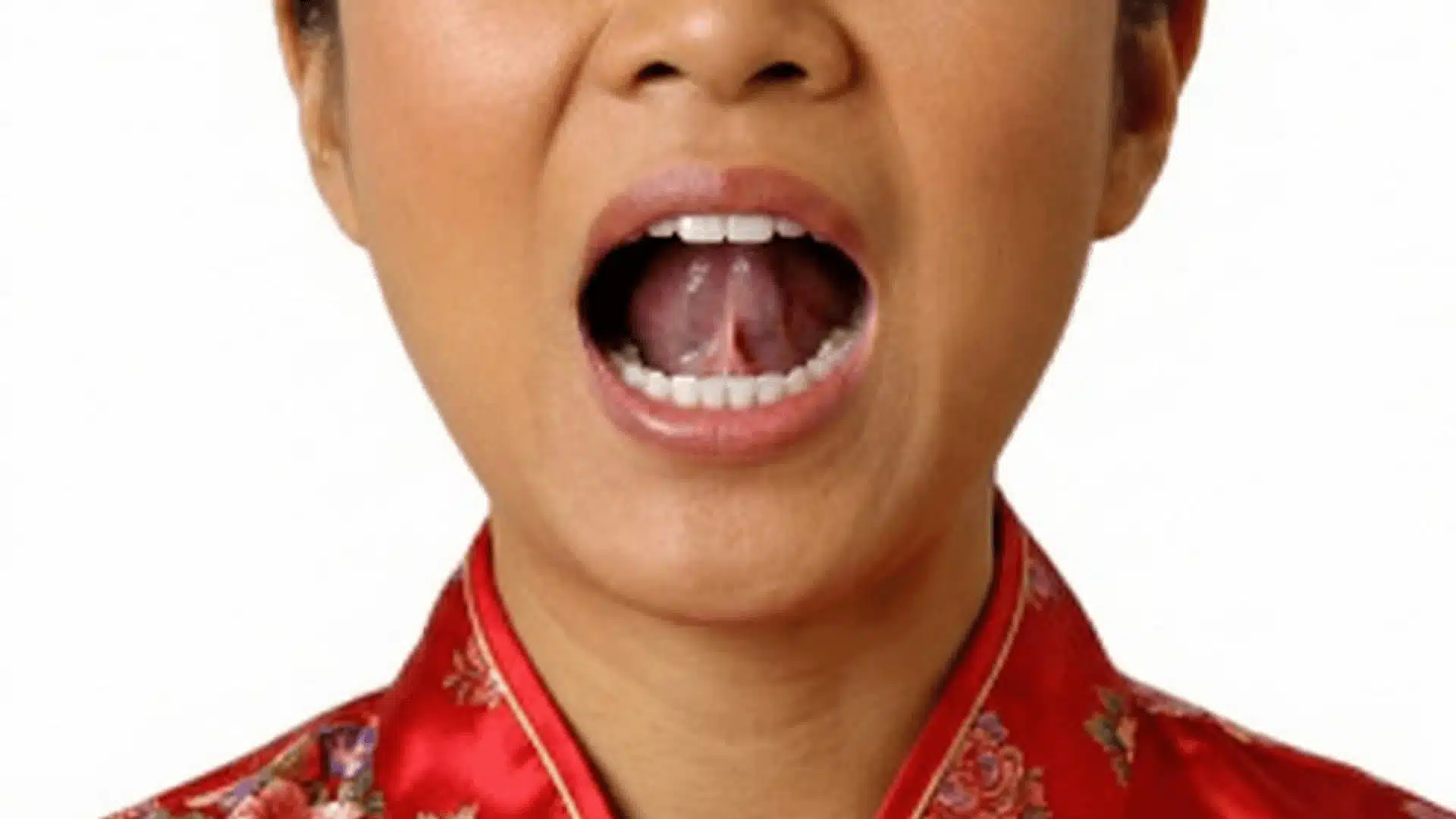 close-up of woman with mouth open and tongue visible demonstrating tongue-to-roof relaxation exercise for tmj relief