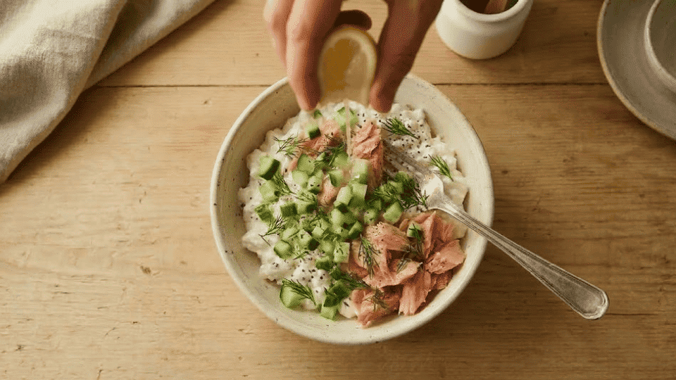 lemon juice dill and black pepper seasoning added to a cottage cheese salmon bowl