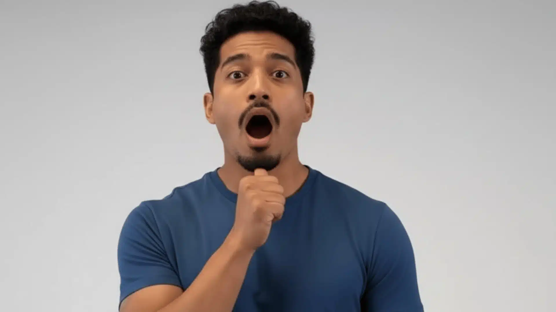 man demonstrating resisted jaw movement exercise with fist under chin and mouth open showing proper resistance technique