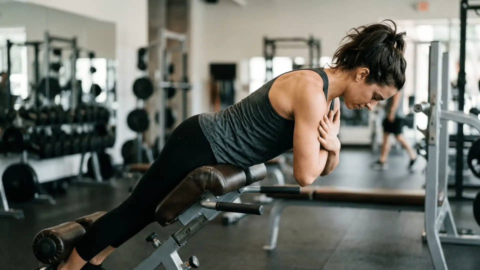 Realistic close-up of a woman the image illustrating back extension movements only there in the gym with her hair tie