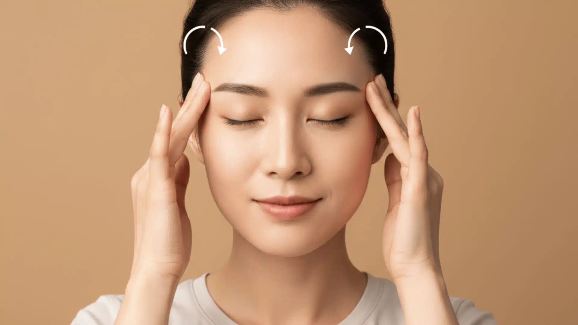 woman massaging temples with fingertips and circular motion arrows showing technique for tmj tension headache relief