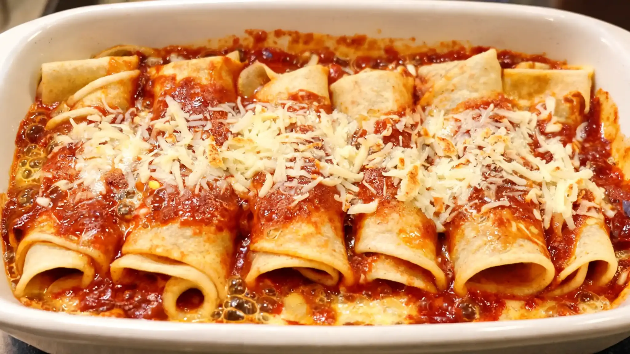 baked chicken enchiladas with homemade sauce and light cheese for a healthier twist on a classic