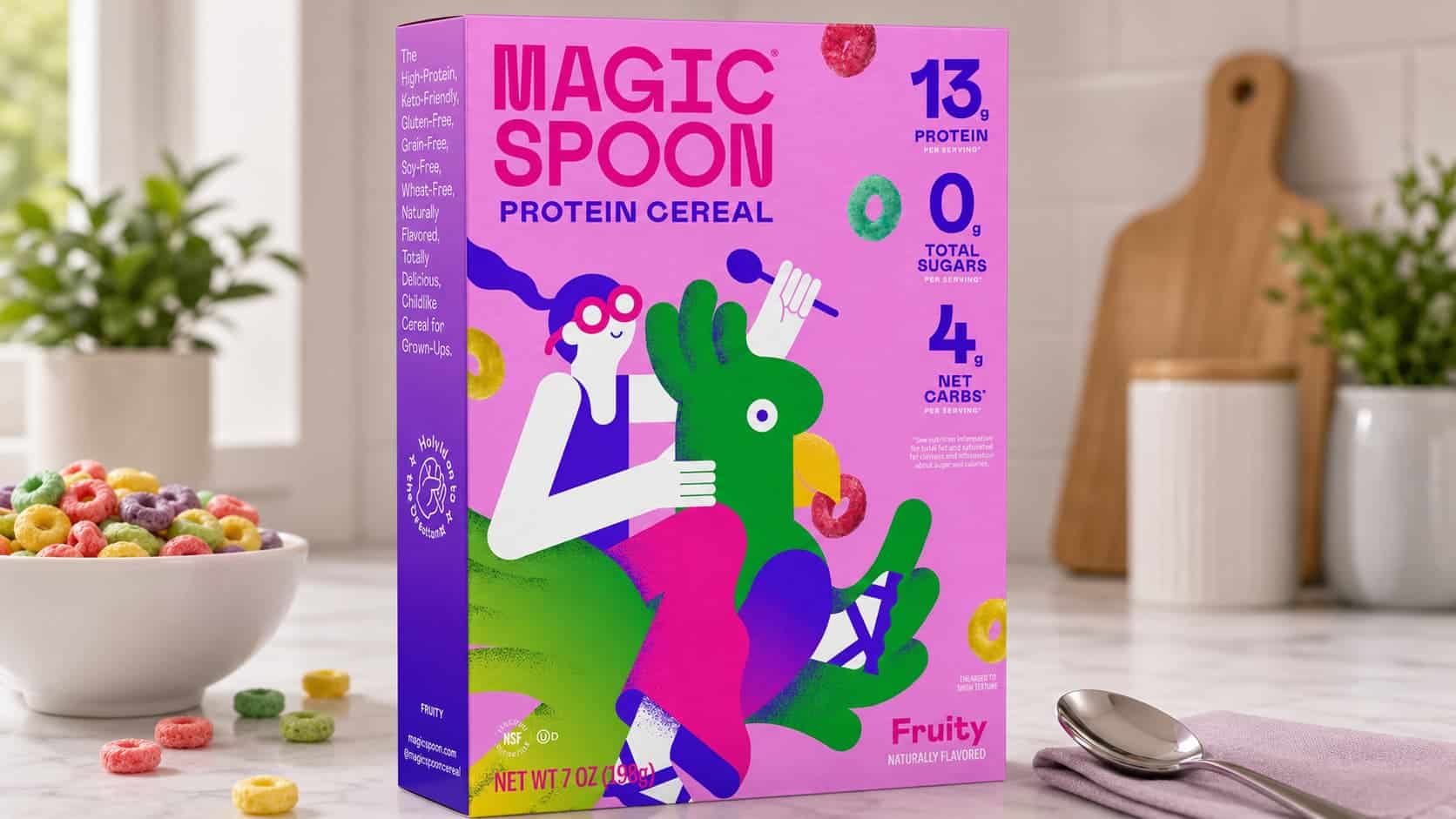 magic spoon fruity protein cereal box with colorful cereal bowl spoon and kitchen counter