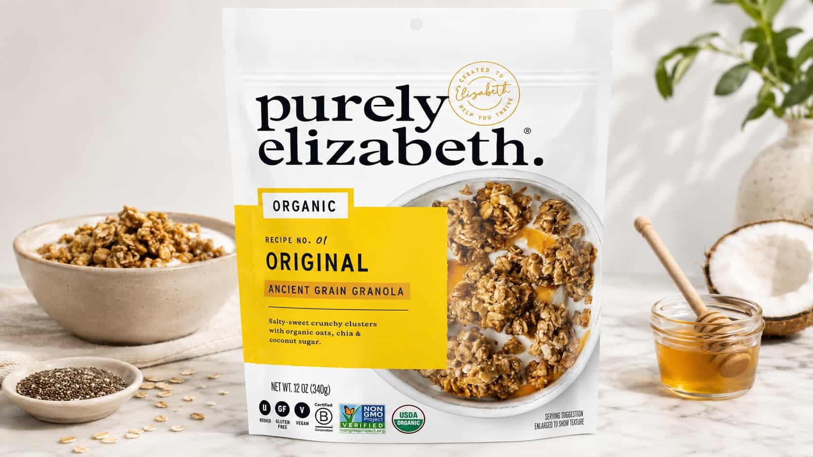 purely elizabeth original granola pouch with bowl honey oats chia and coconut on marble counter