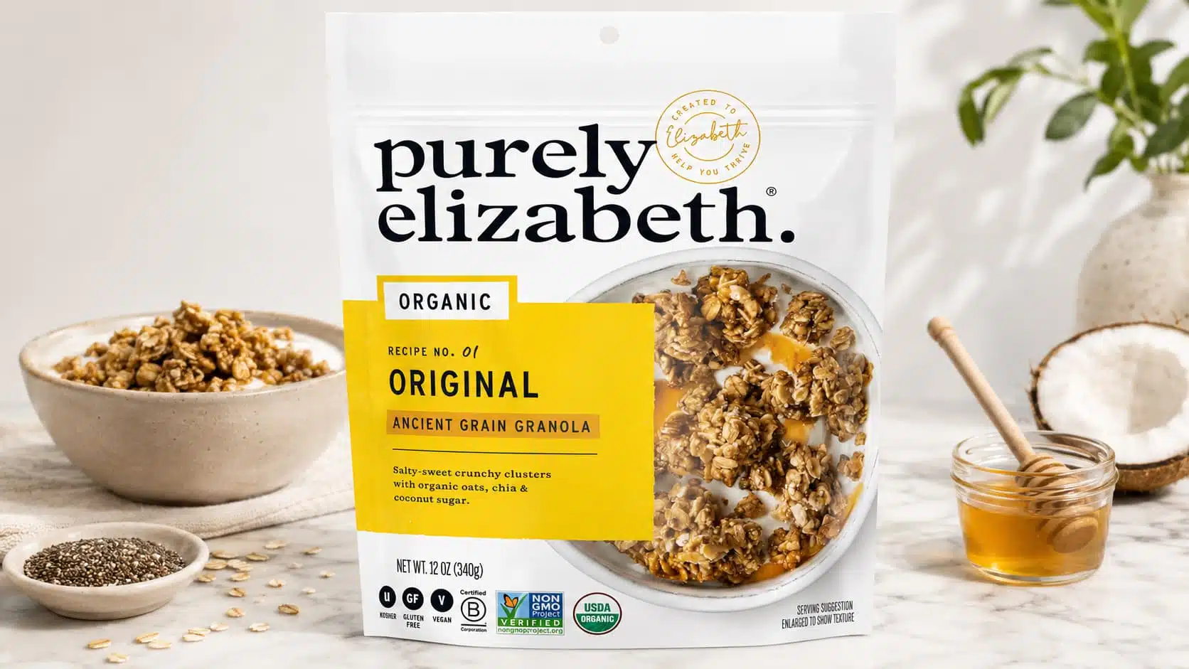 purely elizabeth original granola pouch with bowl honey oats chia and coconut on marble counter