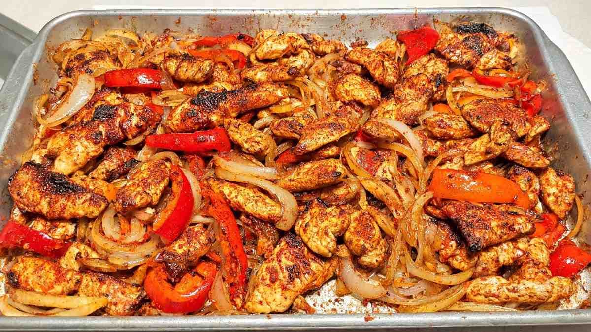 roastedchickenstripswithbellpeppersandonionsseasonedandcaramelizedonasheetpan.11 (1)