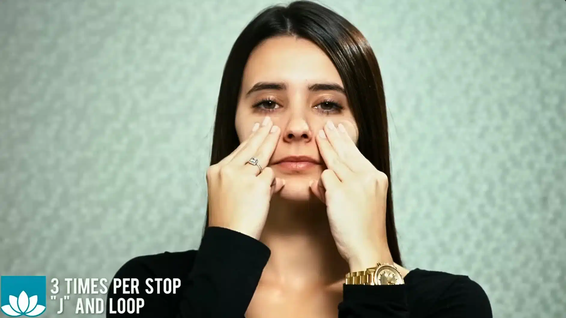 front view of woman demonstrating lymphatic drainage facial massage around nose and cheeks technique