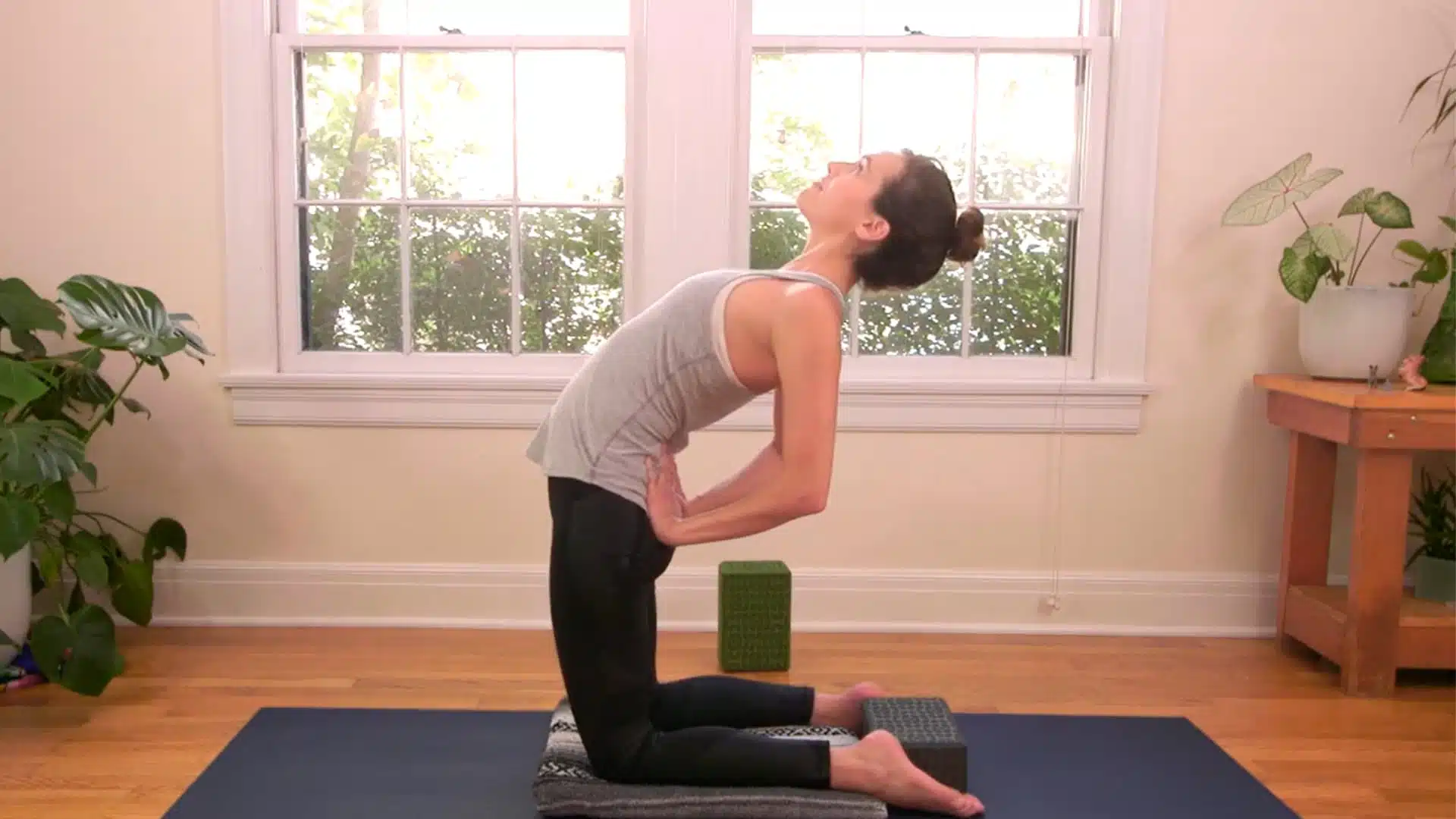 Hands on lower back camel pose beginner version