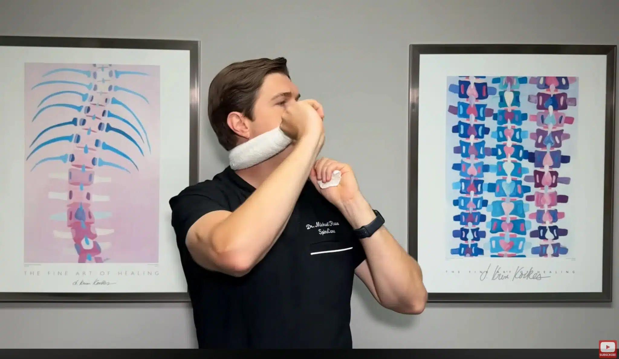 man performing towel neck stretch with towel placed under neck guiding slow head turn technique