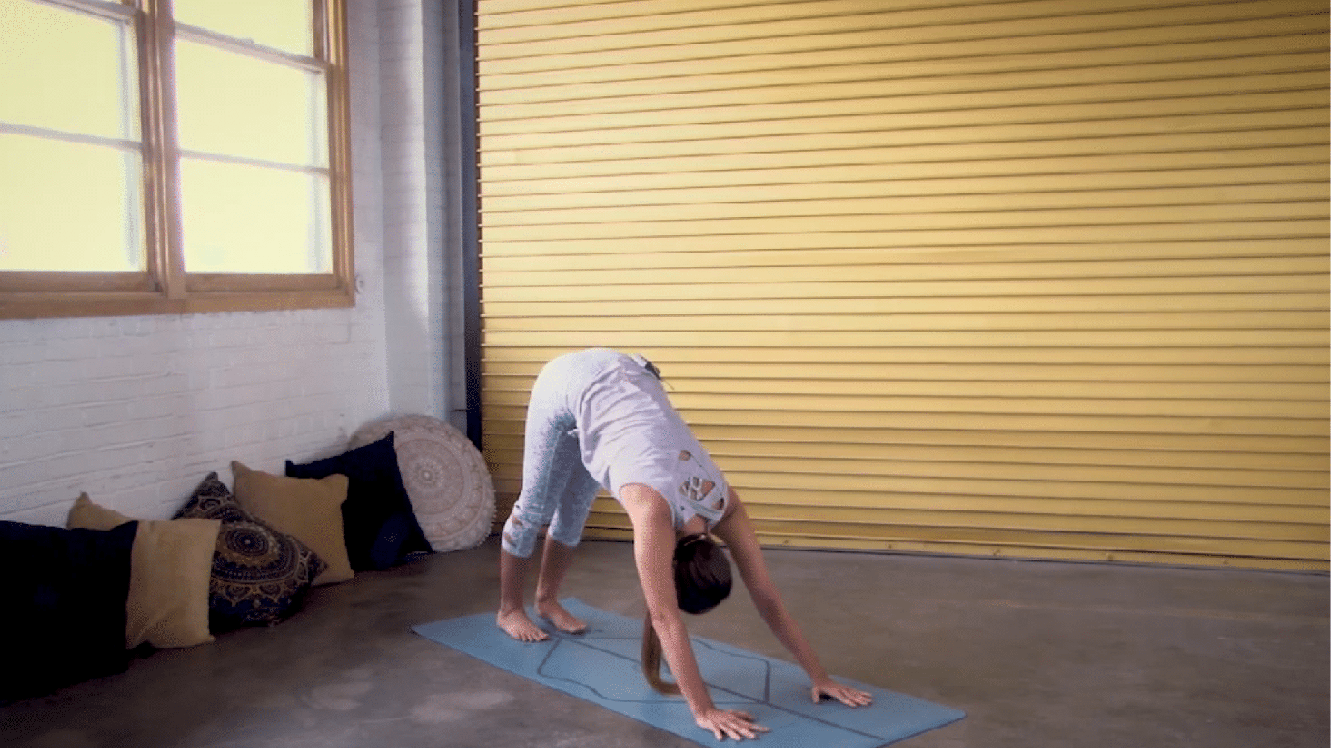 person holding a low lunge stretch with hands on blocks while breathing slowly