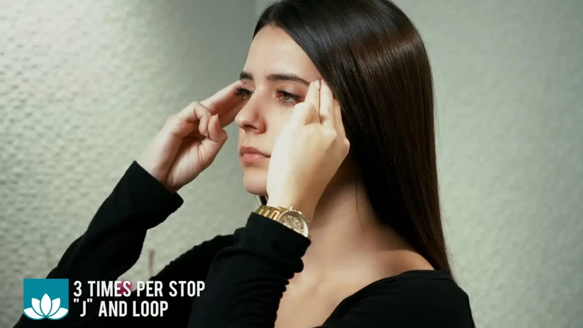side view of woman performing lymphatic drainage facial massage at temples and eye area technique