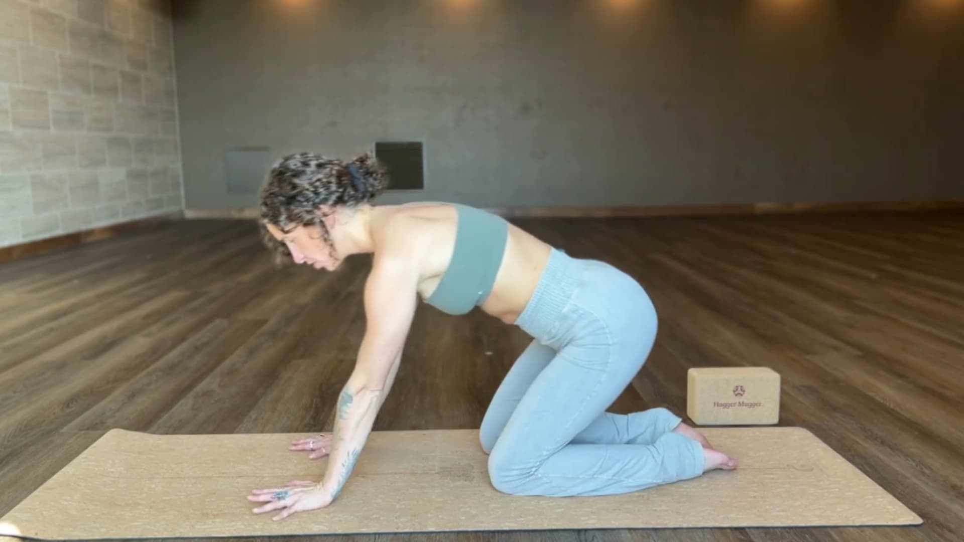 woman moving from tabletop as she walks her hands forward to enter puppy pose