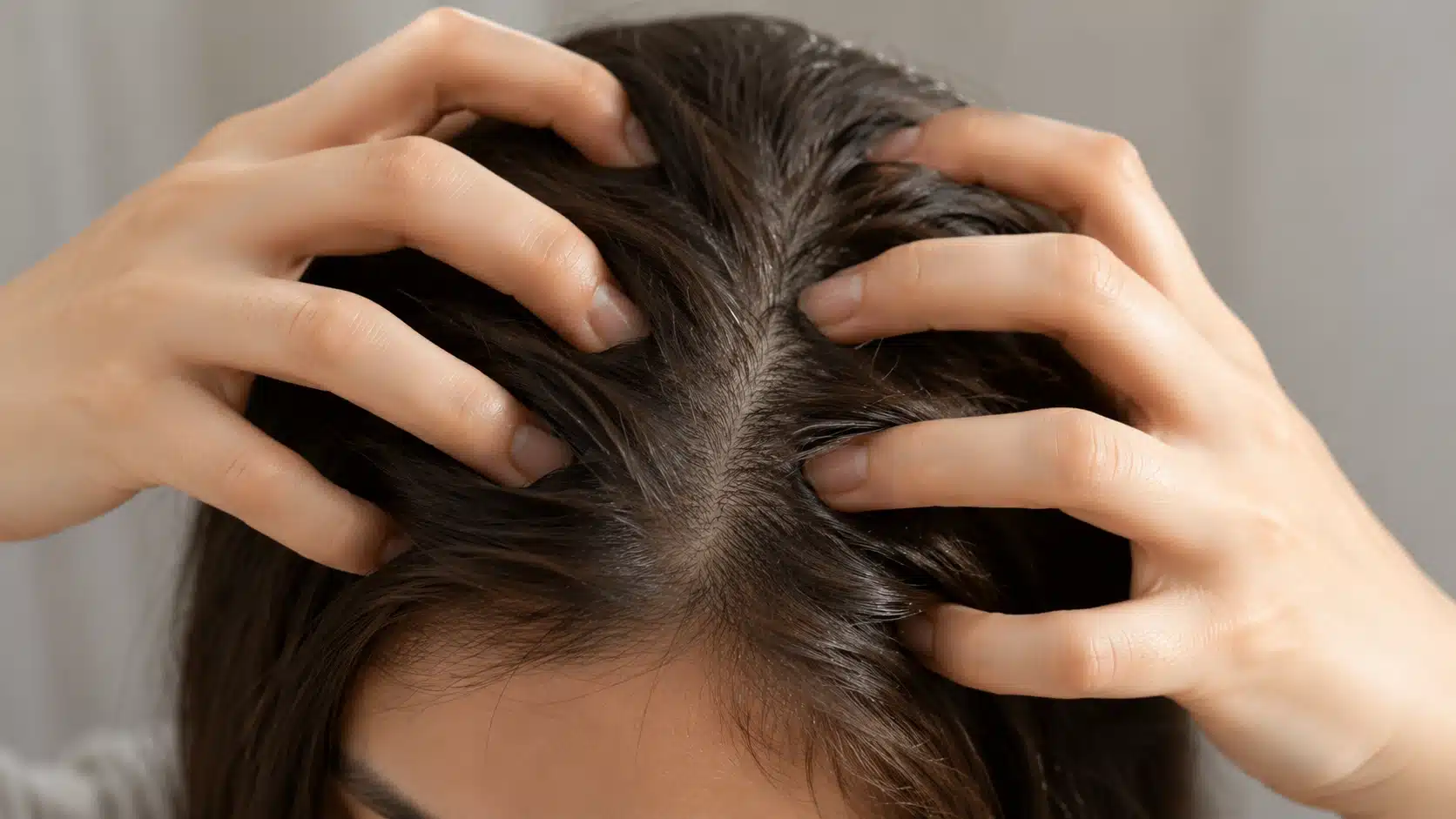 person gently massaging scalp with fingertips showing healthy hair and calm scalp for natural hair care routine