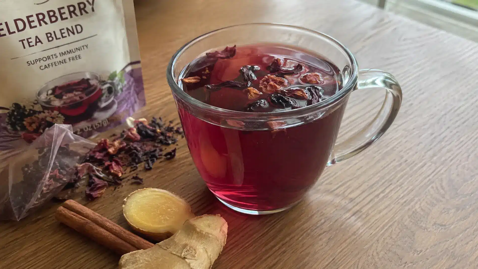 mug of elderberry herbal blend tea with hibiscus and cinnamon nearby